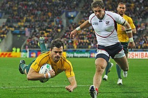 Wing Adam Ashley-Cooper of the Wallabies dives over the line to score his team's seventh try. Photo / Getty Images