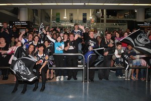 Warriors fans gather to welcome home the team at Auckland International Airport. Photo / Getty Images