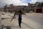 A man carries a shark through the streets of Mogadishu, Somalia. 1st Prize Daily Life Single. Photo / Supplied