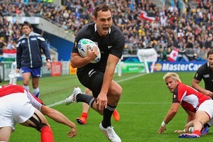 All Black Israel Dagg leaps through the challenge from Matt Evans of Canada to score. Photo / Getty Images