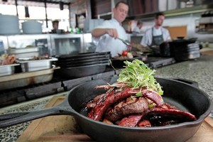 Marvel's mixed grill of eye fillet, lamb cutlet and pork and venison sausages. Photo / Richard Robinson