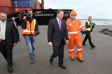 Prime minister John Key speaks to Drew Shannon, a salvage co-ordinator of the Rena clean-up at the Port of Tauranga. Photo / APN 
