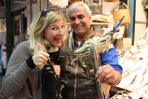 Charlotte with a seafood vendor at Thessaloniki's Modiano Market. Photo / Mauricio Olmedo-Perez