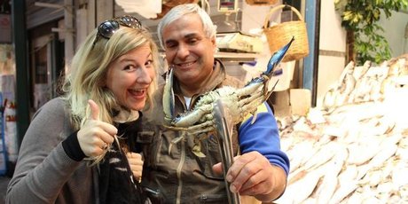 Charlotte with a seafood vendor at Thessaloniki's Modiano Market. Photo / Mauricio Olmedo-Perez