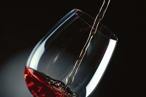 close-up of red wine being poured into a glass