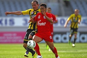 Cassio of Adelaide United (R) is tackled by Lee Bertos of the Wellington Phoenix (L). Photo / Getty Images