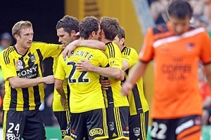 Tim Brown of the Phoenix celebrates with team mates after scoring a goal. Photo / Getty Images