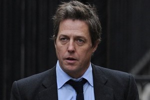 British actor Hugh Grant arrives to attend the Leveson Inquiry in central London. The parents of a murdered schoolgirl whose phone was hacked by the News of the World tabloid, and actor Hugh Grant give evidence on Monday. Photo / AFP