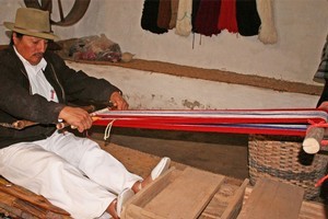 Rafael Cotacachi weaves a strip of cloth with his backstrap loom. Photo / Jim Eagles