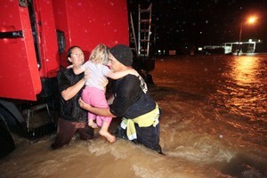 Children are evacuated from flooding threatening the Kaeo Firestation. Photo / NZPA