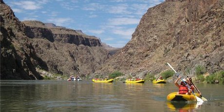 The walls of the Grand Canyon tower above the adventurers on one of the calmer stretches of the Colorado River. Photo / Rob McFarland