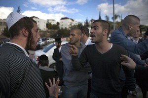 Secular Israelis (R) argue with ultra Orthodox Jewish protesters in the central town of Beit Shemesh, near Jerusalem, on December 26, 2011. Photo / AFP