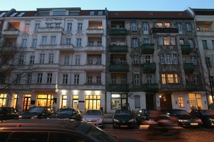 A newly-renovated apartment building (L) and one in a dilapidated state stand in Berlin, Germany. Photo / Getty Images