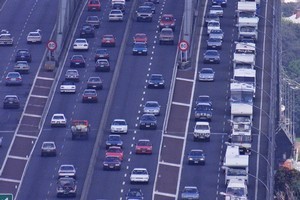 Campervans head over the Harbour Bridge. Photo / Martin Sykes