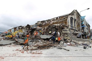 Rescue workers search for survivors through the debris. Photo / Getty Images