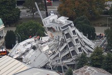 Rescue workers on the collapsed Pyne Gould Guiness Building in central Christchurch. Photo / Mark Mitchell