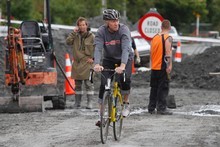 Phil Taylor takes a bike ride along the damaged roads. Photo / Mark Mitchell
