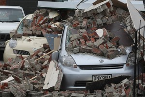 Cars covered in rubble after the earthquake in Christchurch. Photo / Greg Bowker