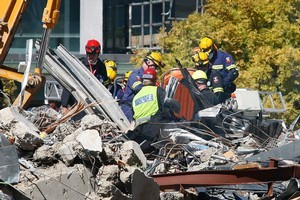 Members of the NZW search and rescue team work to recover bodies from the site of the CTV building in central Christchurch. Photo / Sarah Ivey
