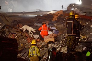 Emergency services search the rumble for survivors of the collapsed CTV building in Madras Street. Photo / Brett Phibbs