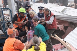 Emergency services and volunteers rescue people from the collapsed CTV building. Photo / Geoff Sloan