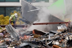 Emergency workers search the wreckage of a building after the Christchurch earthquake. Photo / Brett Phibbs