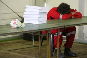 A Red Cross worker sleeps at the Civil Defence Emergency Centre. Photo / Greg Bowker