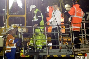 A survivor is lifted down by crane after being rescued from the wreckage of the collapsed Pyne Gould Corporation building yesterday. Photo / Mark Mitchell
