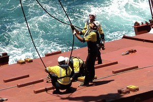 Riggers prepare a hatch cover for removal of a container on the Rena. Photo / Maritime NZ