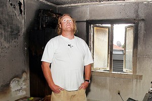 Owner Seamus McKenna surveys the damage after a fire at his Ranch Road house in Mount Maunganui. Photo / Mark McKeown