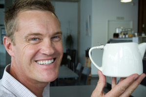 Johno Evans, co-owner of the Urban Cafe, with a teapot similar to the one that raised $6000 for Warkworth Hospice. Photo / Paul Estcourt