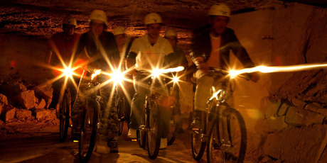 Cyclists don mining helmets to tackle the tunnels at Valkenburg. Photo / Supplied