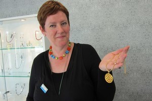Beadz Unlimited shop assistant Paula Cornborough with one of its rose window pendants. Photo / Amanda Cropp