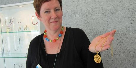 Beadz Unlimited shop assistant Paula Cornborough with one of its rose window pendants. Photo / Amanda Cropp