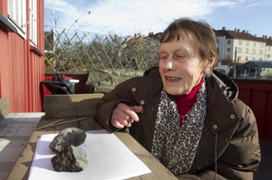 Anne Margrethe Thomassen looks at what is thought to be a meteorite that split in two after hitting the roof of her cottage in central Oslo on March 12, 2012. The meteorite was discovered on March 1