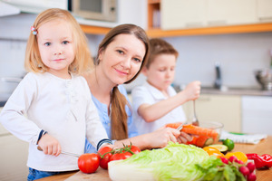 Getting the kids involved in preparing healthy meals and snacks is a good way to promote nutrition. Photo / Getty Images