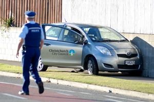 Police examine a crashed Christchurch City Council car that was part of the scene today following a man's rampage. Photo / Geoff Sloan