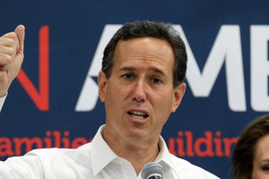 Republican presidential candidate, Rick Santorum talks to supporters while his wife, Karen, looks on during a rally. Photo / AP