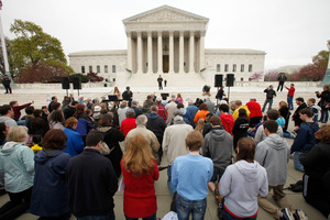 Christians kneel on the footpath in front of the Supreme Court as part of 'Encircle the Court in Prayer,' on the eve of arguments on healthcare legislation. Photo / AP