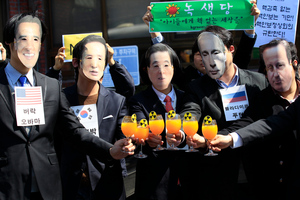 Protesters wearing masks of world leaders protest against the Nuclear Security summit in Seoul. Photo / AP