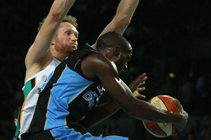 Luke Schenscher of the Crocodiles blocks Cedris Jackson of the Breakers during game one of the NBL finals series.