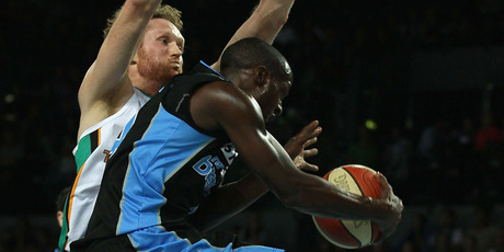Luke Schenscher of the Crocodiles blocks Cedris Jackson of the Breakers during game one of the NBL finals series.
