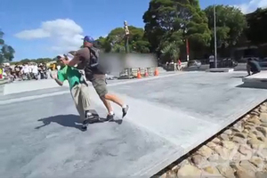 A young skater is pushed over by a man during the Skinny & Serenity National Grom Skate Comp. Photo / Supplied