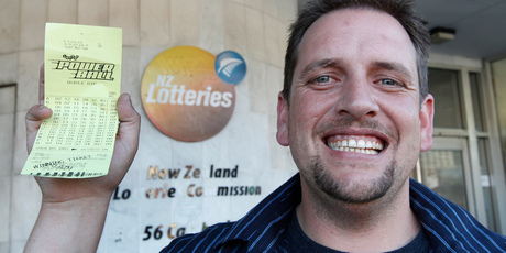 Te Kauwhata supermarket check-out operator Trevor with his winning $26,000,000 Lotto ticket at the NZ Lotteries Commission in Wellington. Photo / Mark Mitchell