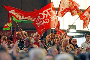 Supporters of Jean Luc Melenchon, leader of France's leftist political party Front de Gauche, and candidate for the 2012 French presidential elections wave flags during an electoral meeting. Photo / AP