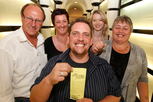 Trevor, family and friends, and his winning Lotto ticket. Photo / Supplied