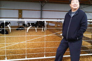 Shanghai Pengxin chairman Jiang Zhaobai inspects a Waikato dairy shed. Photo / Supplied