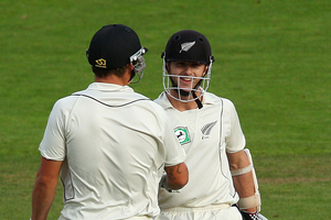 Kane Williamson of New Zealand celebrates his century with teammate Doug Bracewell. Photo / Getty Images