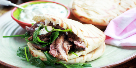 Roasted lamb shoulder with pita and rocket. Photo / Doug Sherring