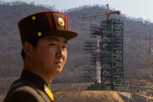 2012 file photo, a North Korean soldier stands in front of the country's Unha-3 rocket, slated for liftoff between April 12-16, at a launching site in Tongchang-ri. Photo / AP